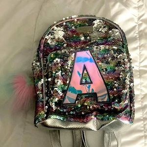 Sequence letter A Backpack with puff ball.
